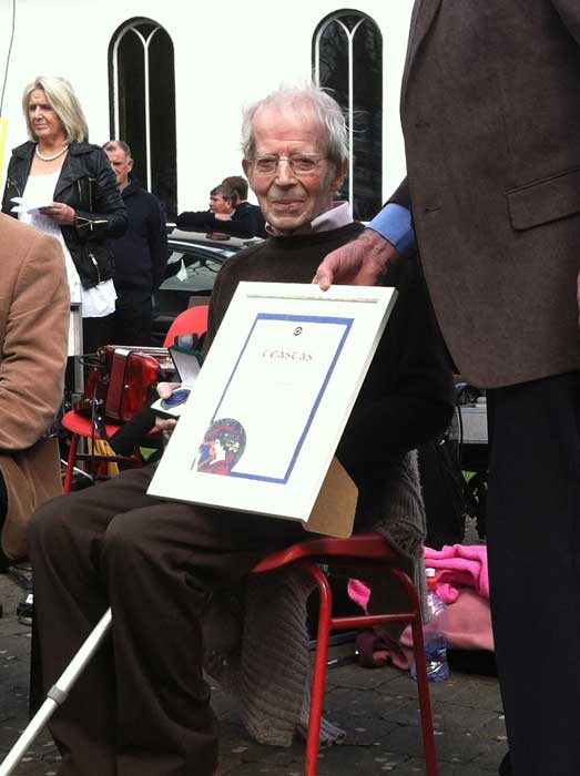 Paddy Murphy displaying his medal and certificate